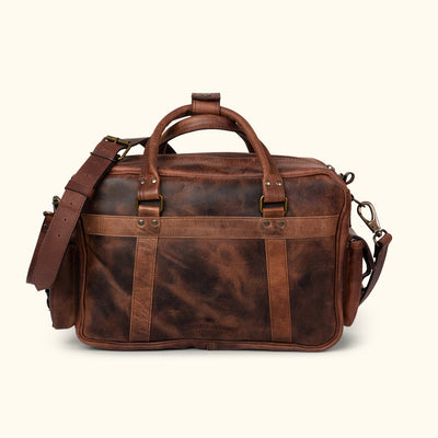 Men's rugged dark oak leather pilot bag showcasing a detailed rear view with multiple secure pockets, adjustable shoulder strap, and robust handles. Ideal for versatile use.